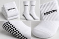 White women's Pilates crew grip socks with black OBSYRN branding