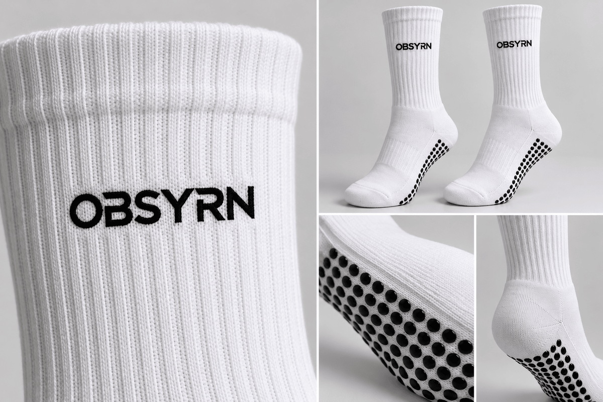 White OBSYRN crew grip socks with black non-slip Pilates grips on the soles